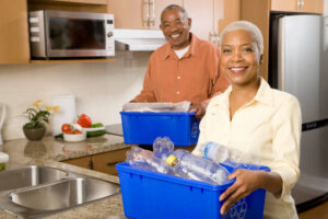Black couple doing recycling in the kitchen